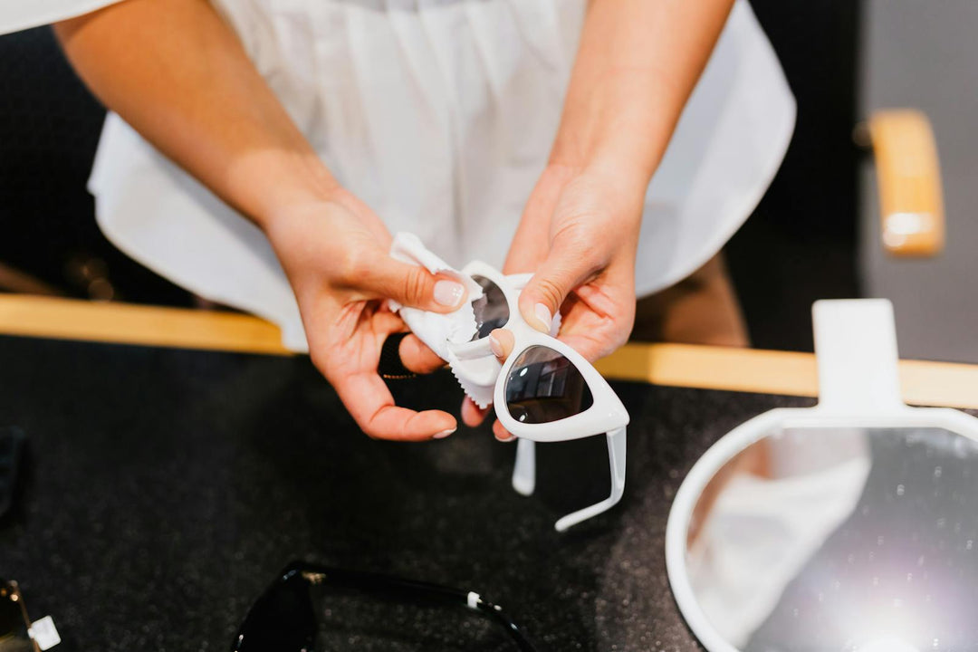 Cleaning sunglasses lenses with a microfiber cloth