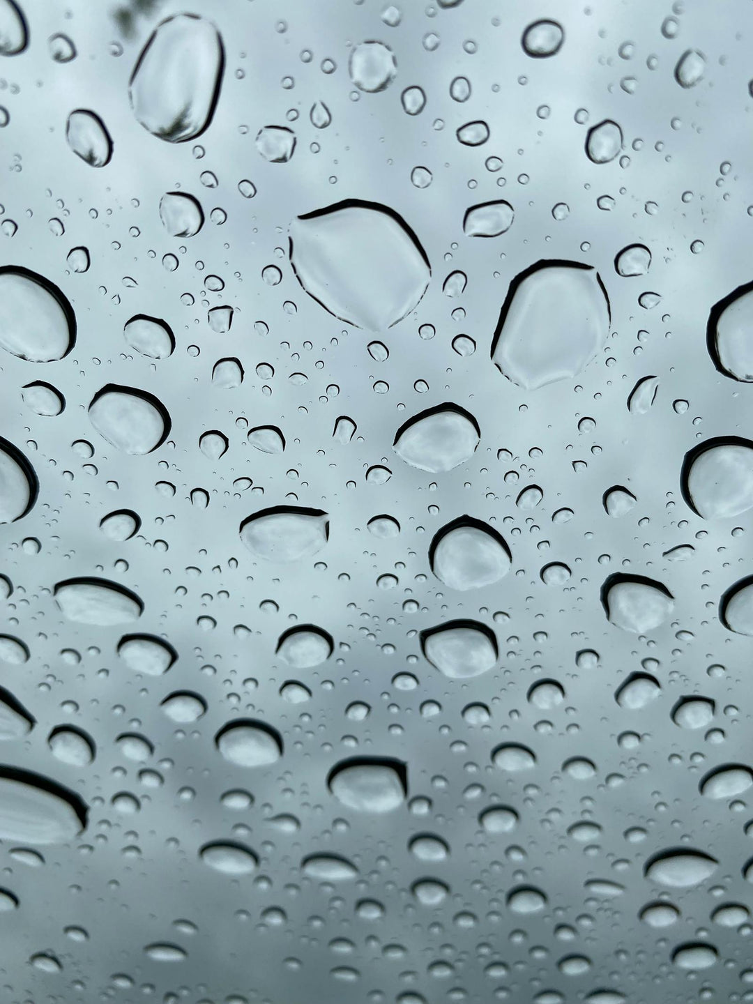 Water droplets beading on glass