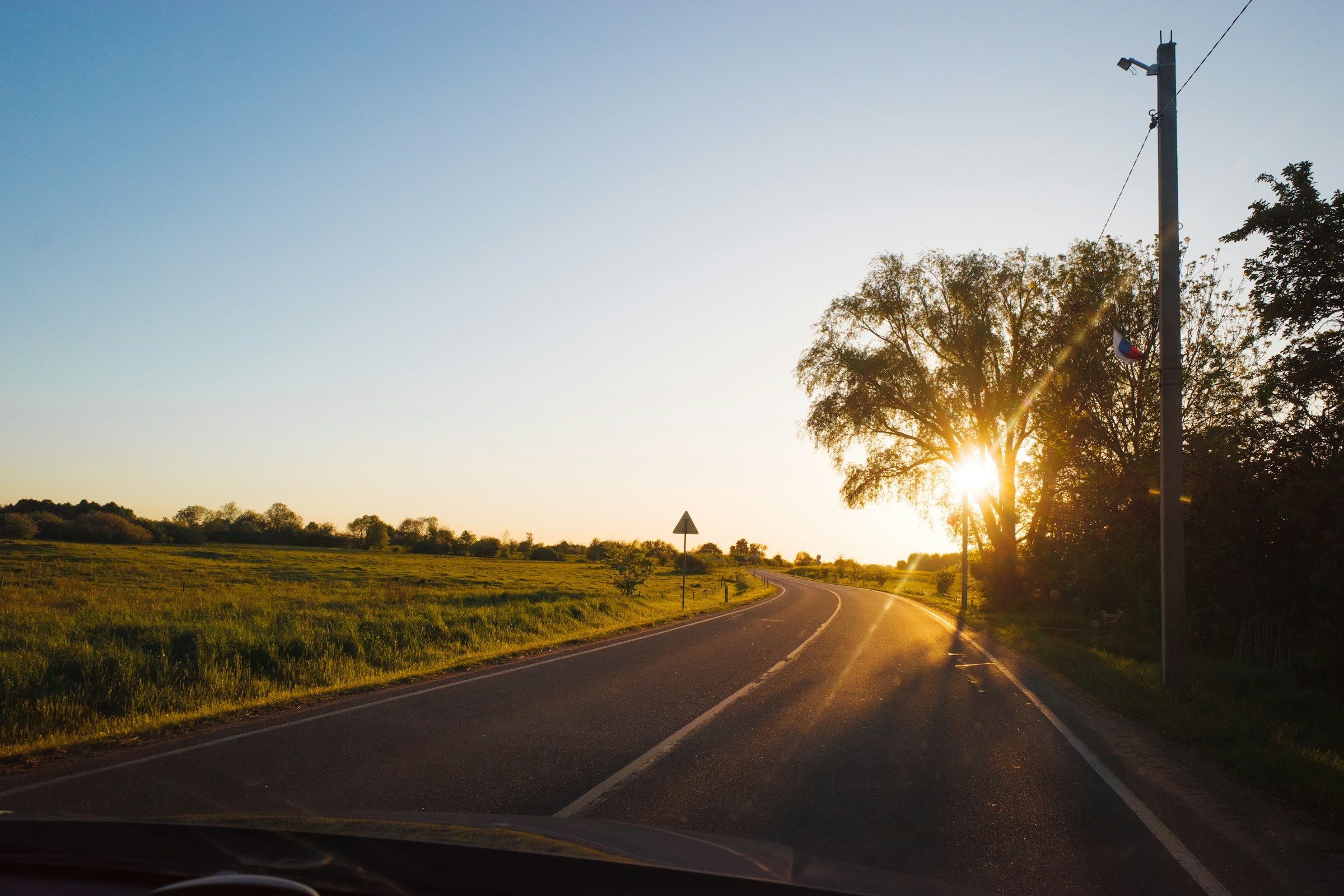 Winding road at sunset — photo by Alexander Lunyov on Unsplash